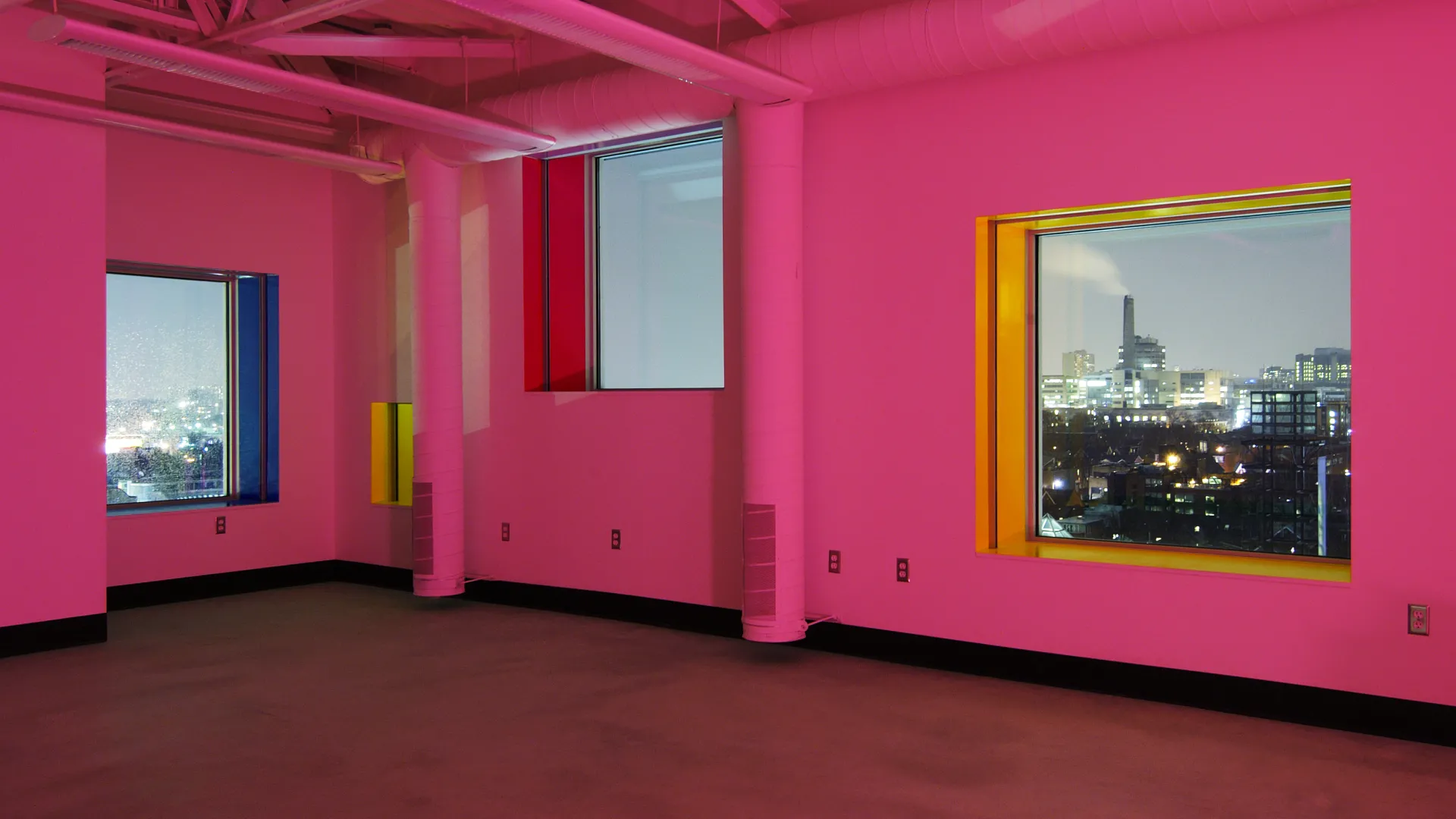 Interior of the Sharp Center, with walls drenched in pink lights