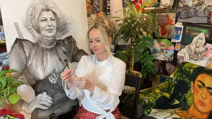 Erin Finley in studio with drawing