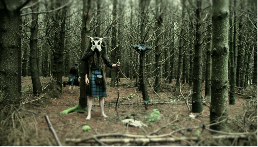 Person in mask standing in forest