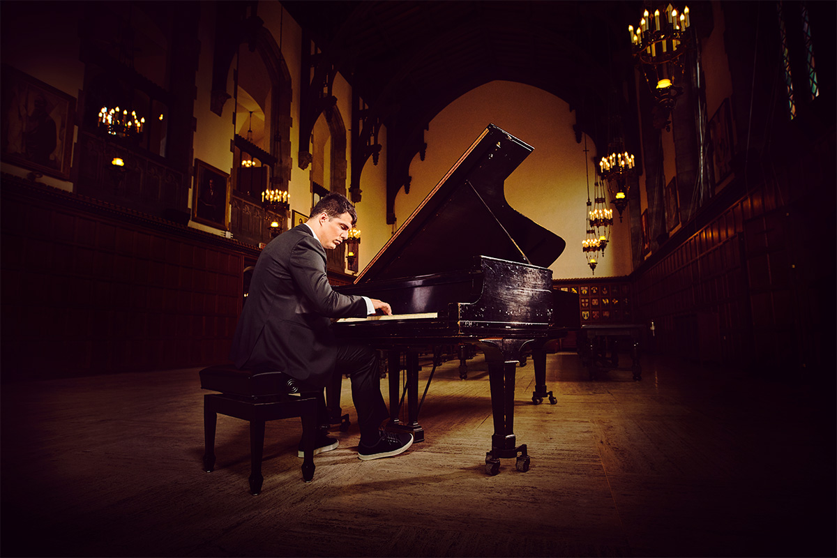 A man playing a grand piano