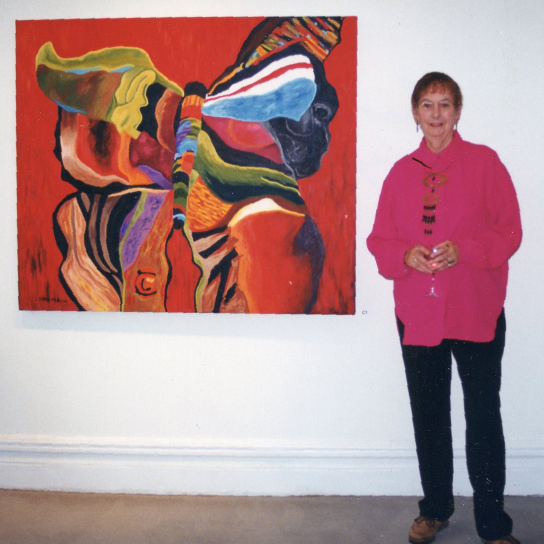 Lois Stten standing in front of painting named Butterfly