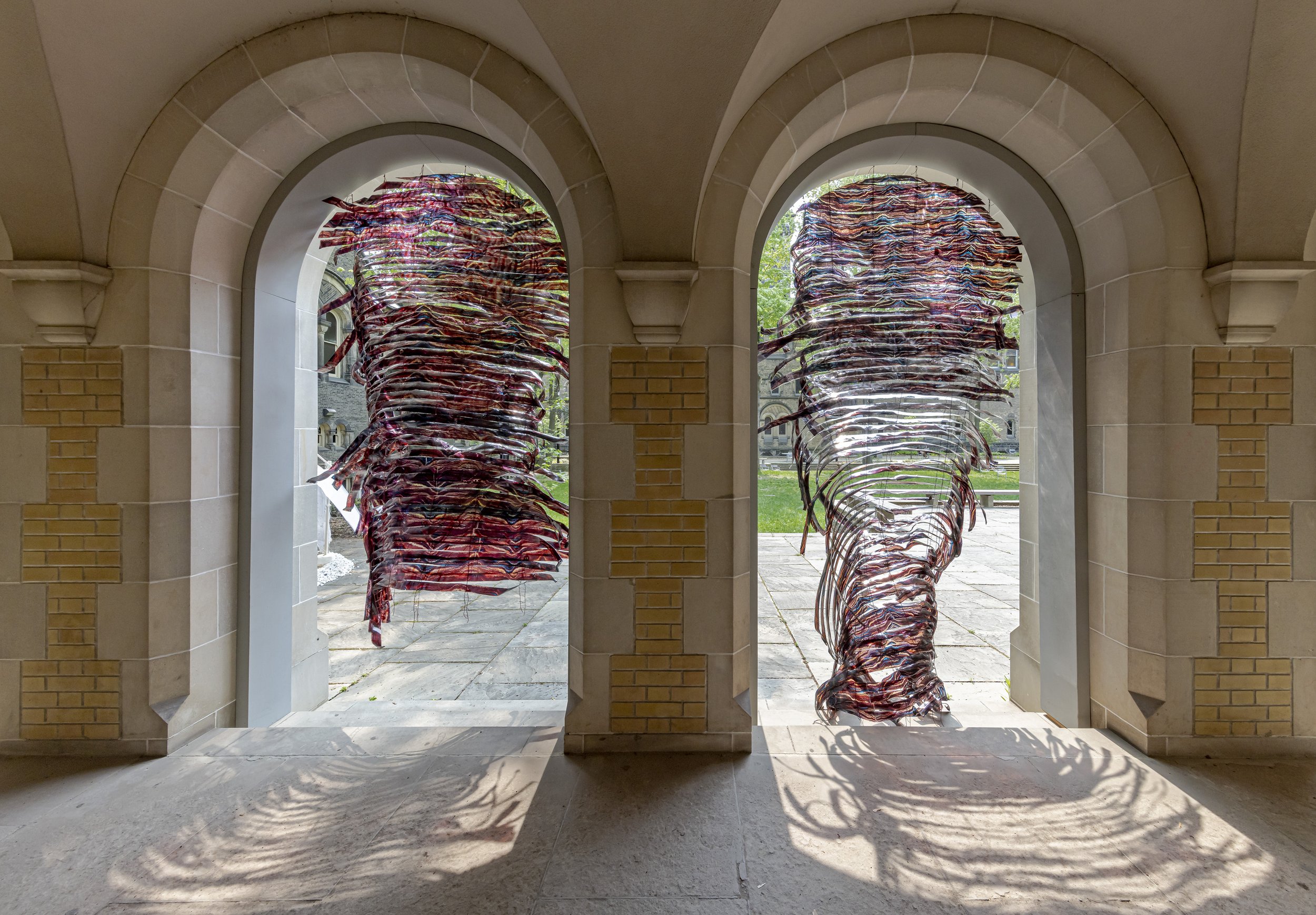 Two stone archways with art installed inside them