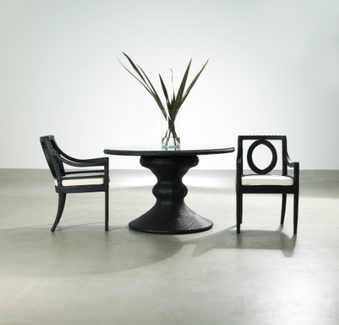 A circular table and two chairs in a room.