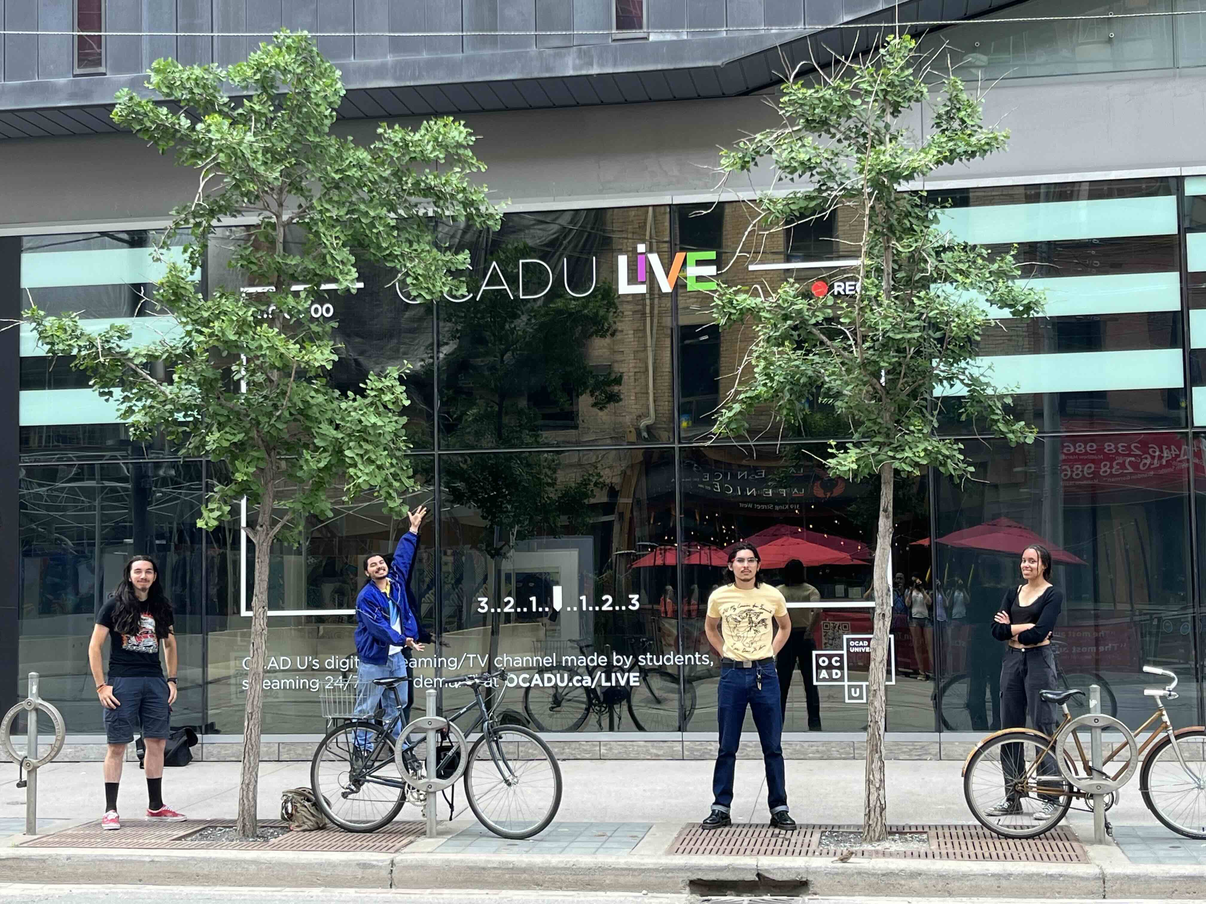 4 students in front of building