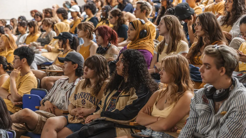 A large group of students sitting in an auditorium.