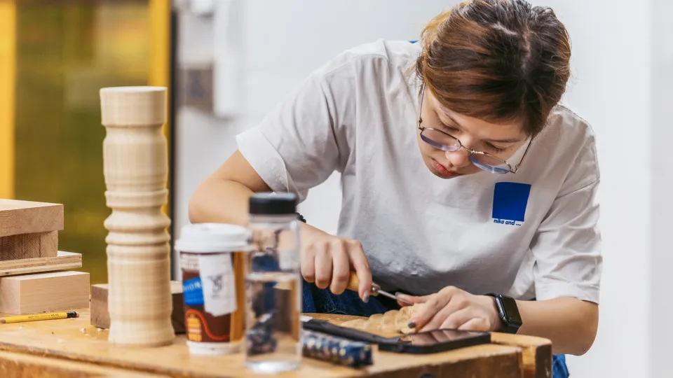 A student carving wood.