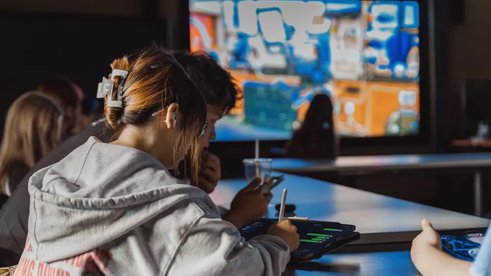 Student working at a table a classroom