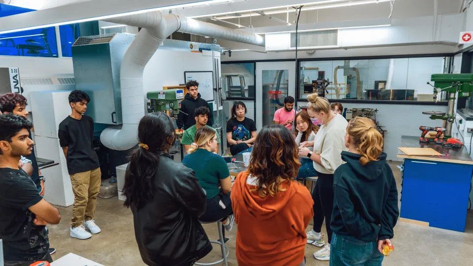 Group of students standing in a studio.