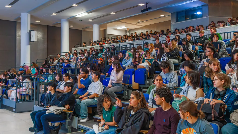 Lecture hall seating full of students 