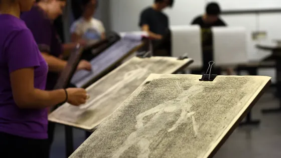 A close up photo of a drawing board with a life drawing sketch.