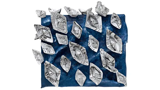 Folded paper boats on a blue background