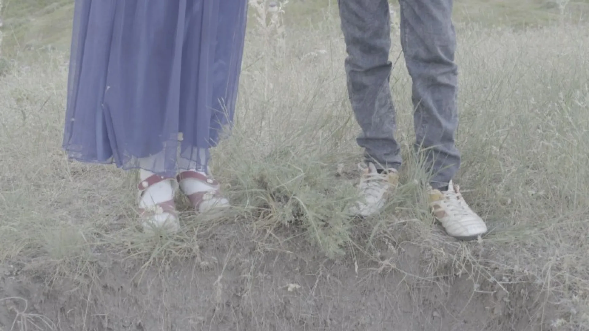 Feet standing in grass.