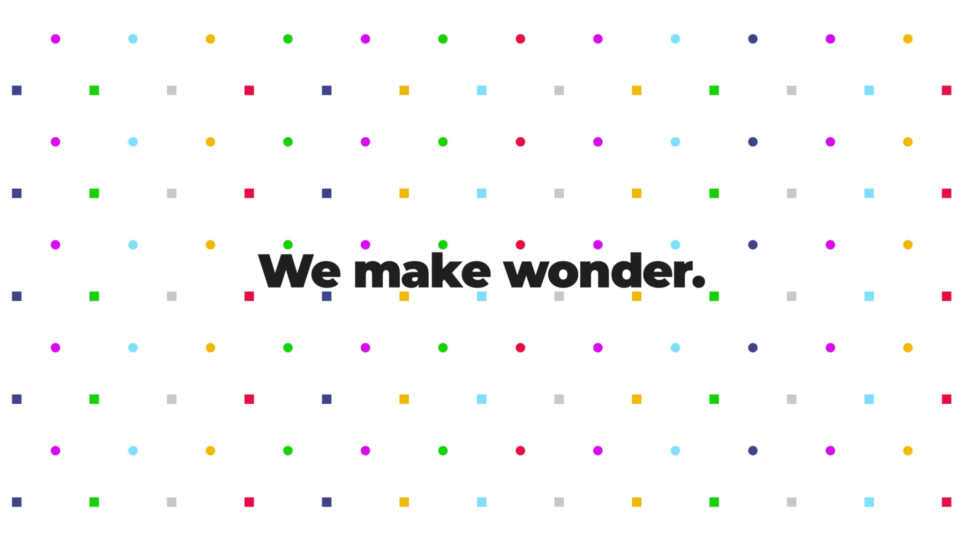 White background with colourful dots in foreground. Black text in center: "We make wonder.".