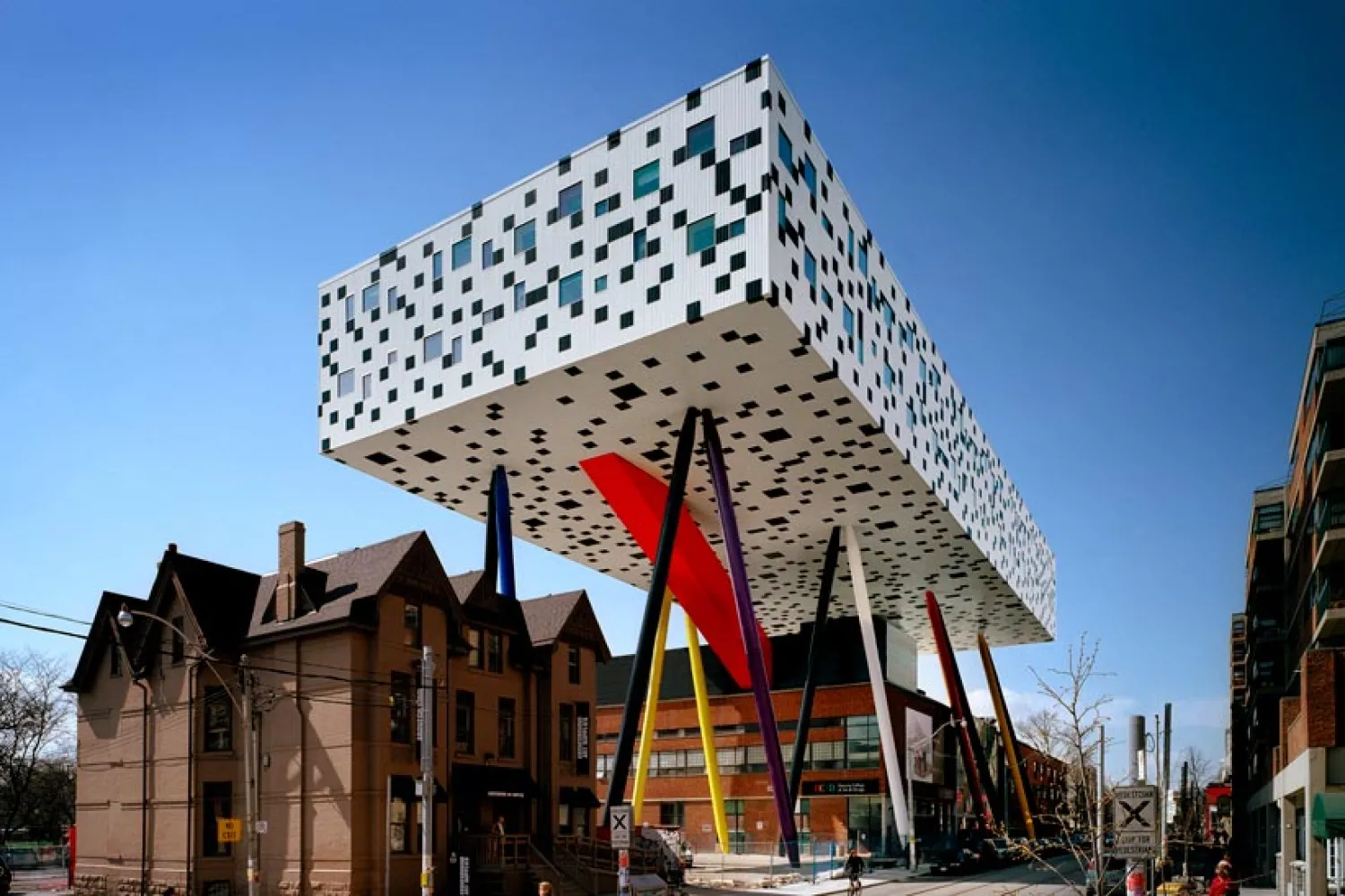 OCAD University's Sharp Centre for Design, with a graphic black and white facade suspended over primary colour support legs