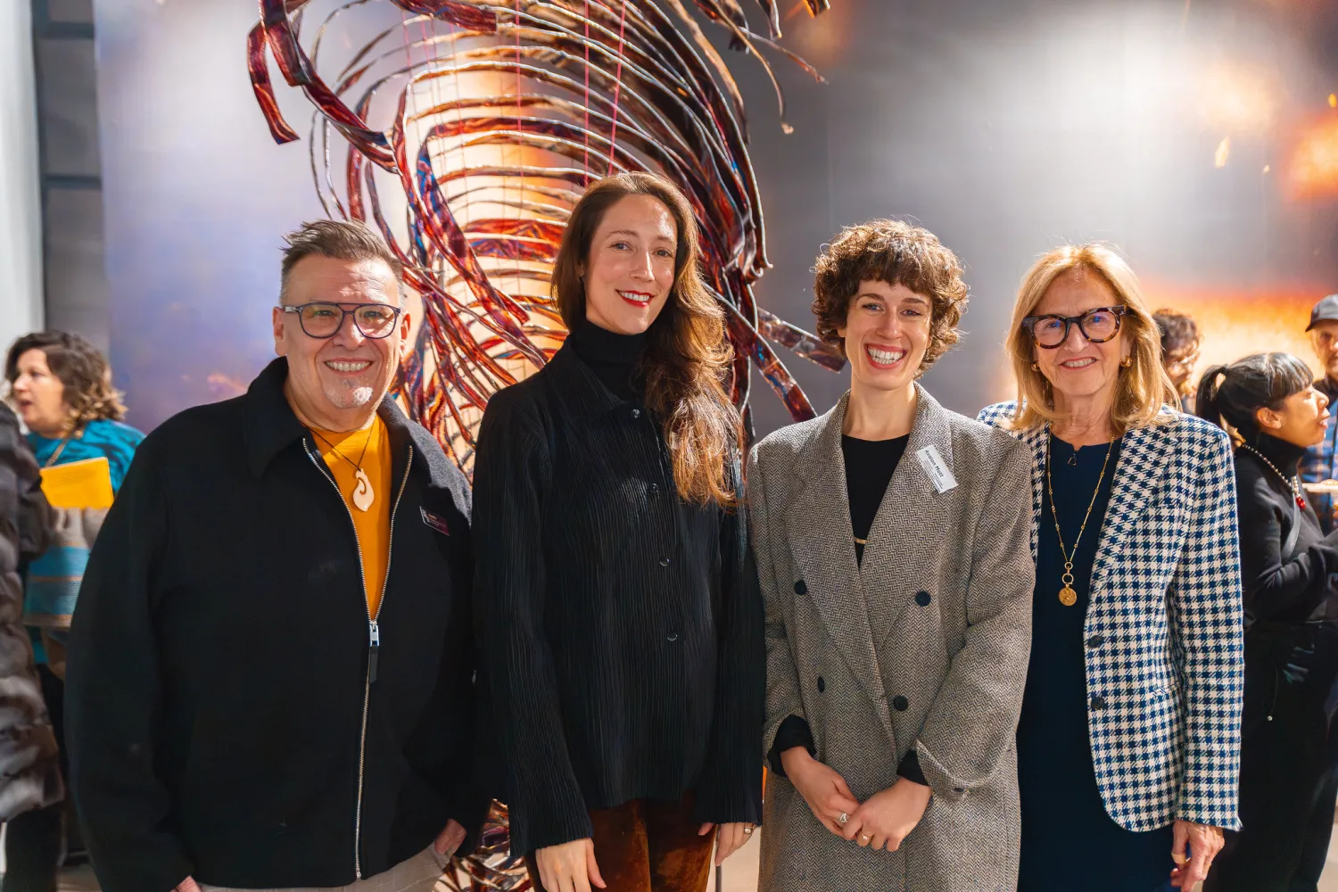 Group of people posing for a photo in an art gallery