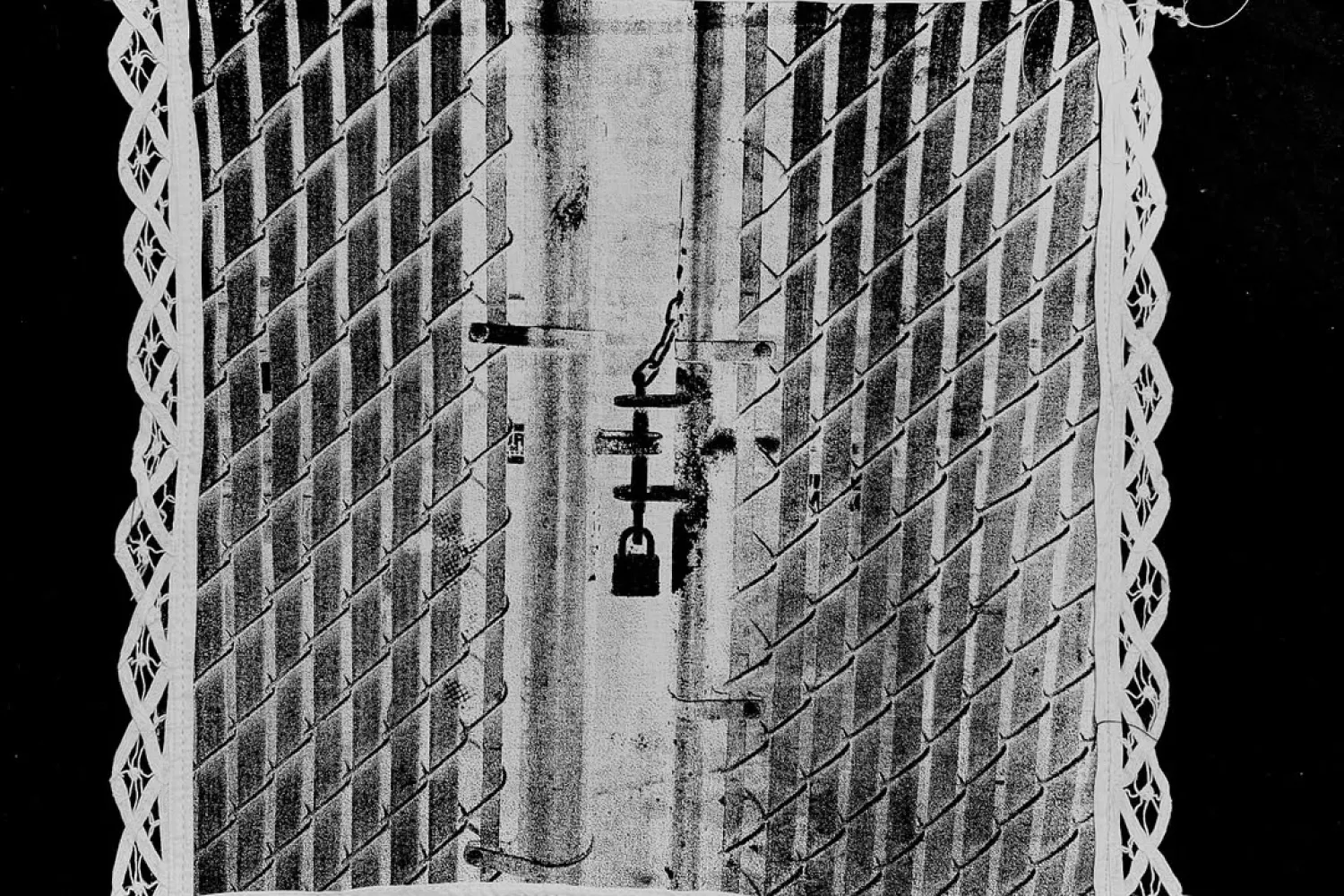 Black and white image of white square with a door with a lock on it