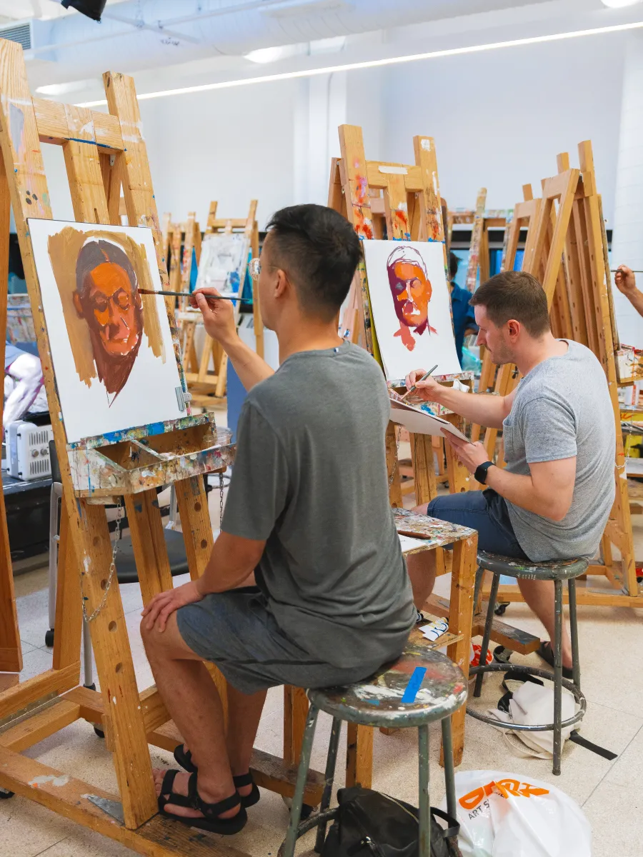 Student painting in a studio