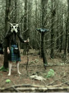 Person in mask standing in forest