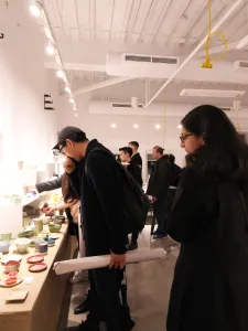 People viewing art for sale at a marketplace