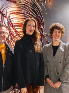 Group of people posing for a photo in an art gallery