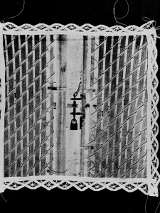 Black and white image of white square with a door with a lock on it