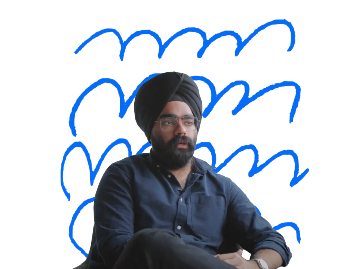 Sikh man sitting in front of transparent background with blue squiggles