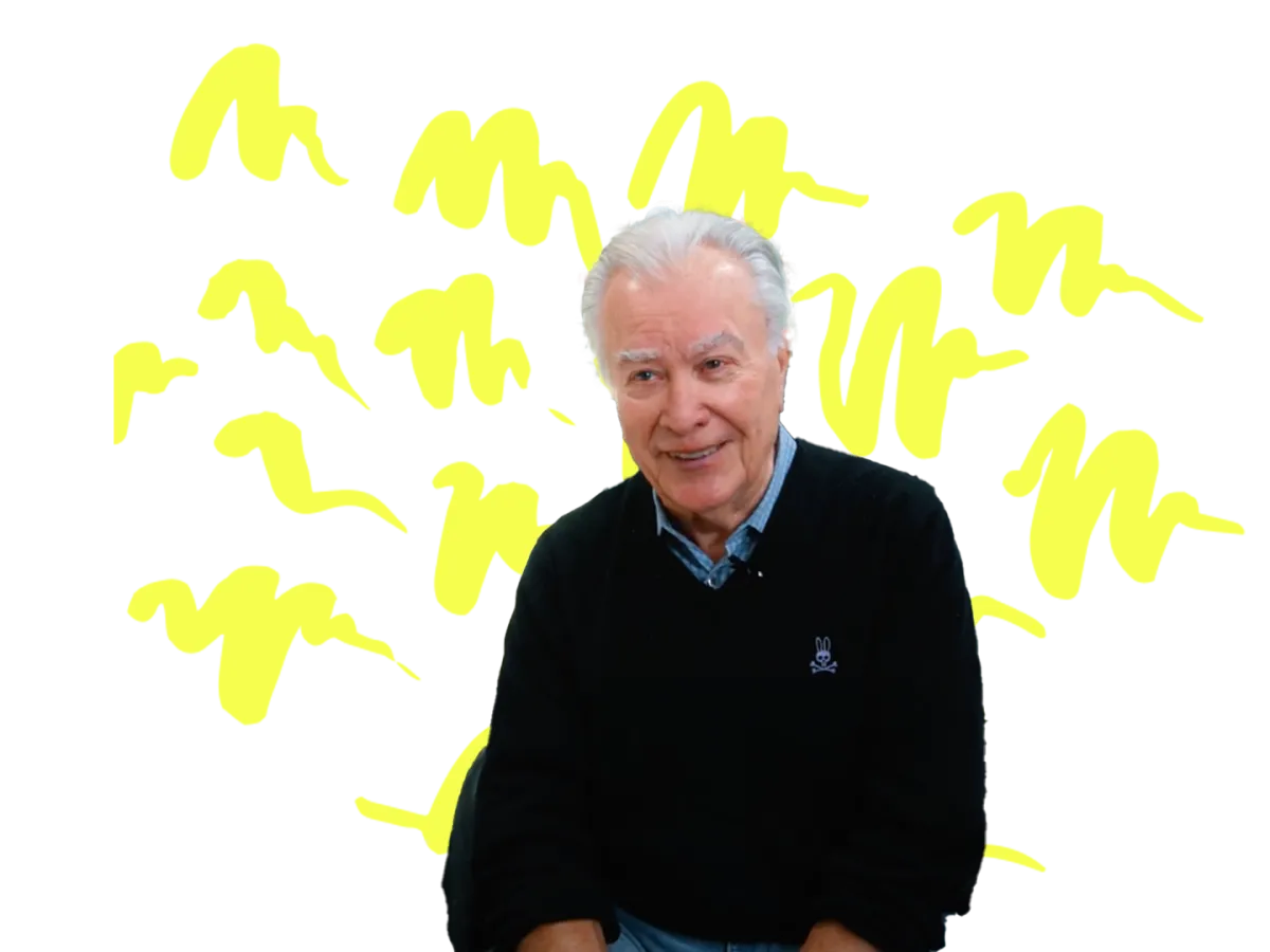 Man sitting in front of transparent background with yellow squiggles