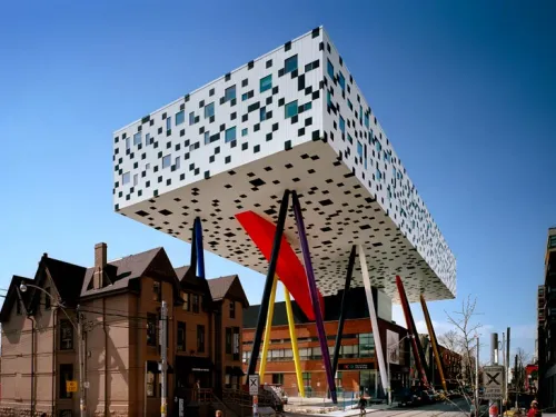 OCAD University's Sharp Centre for Design, with a graphic black and white facade suspended over primary colour support legs