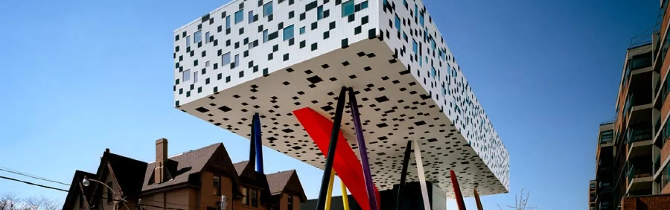 OCAD University's Sharp Centre for Design, with a graphic black and white facade suspended over primary colour support legs