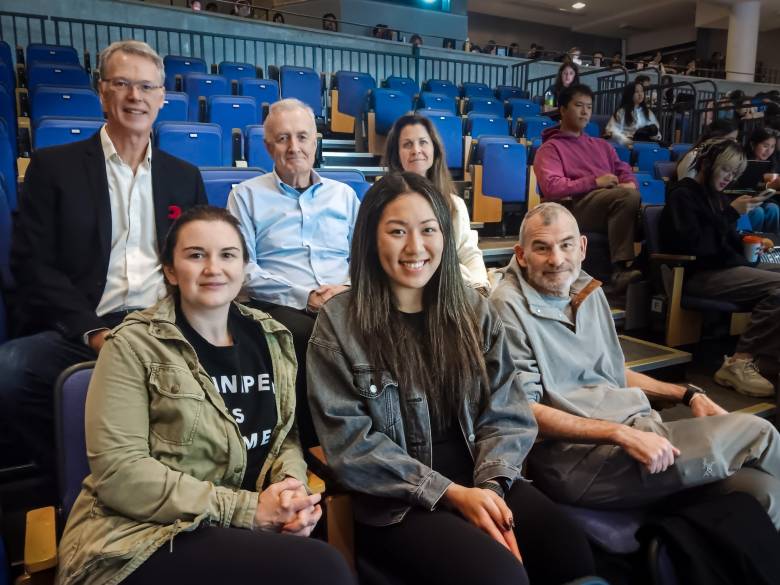 Six University of Toronto surgeons, three in top row and three in bottom row, in an auditorium at OCAD University. 