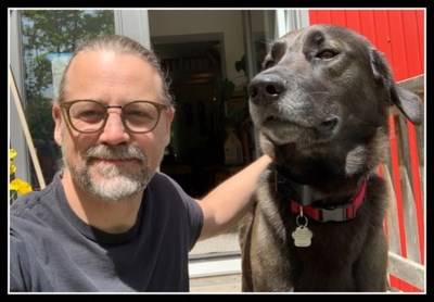 Former faculty and staff member John Kuisma with a dog.