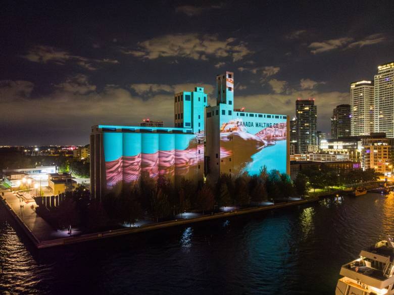 A photo of the Canada Malting Silos at night with a projection of "Riparia."