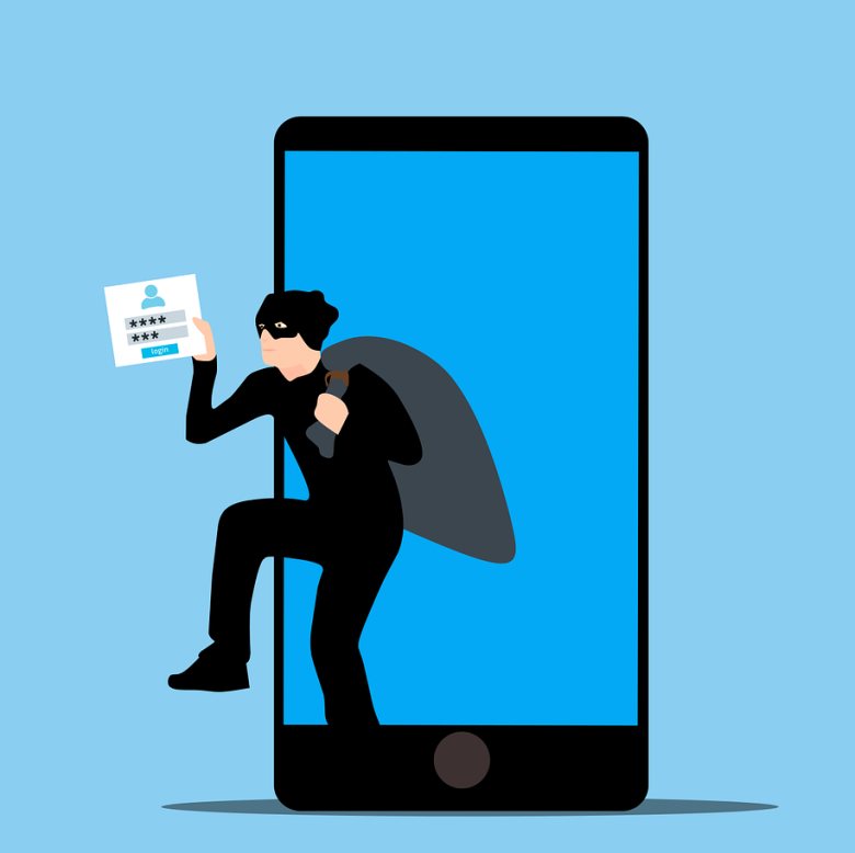 A person wearing all black clothing and a mask emerges from a cellphone holding a card that shows login credentials.