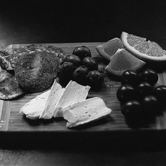 A fruits and cheese board photography from student in B&W course