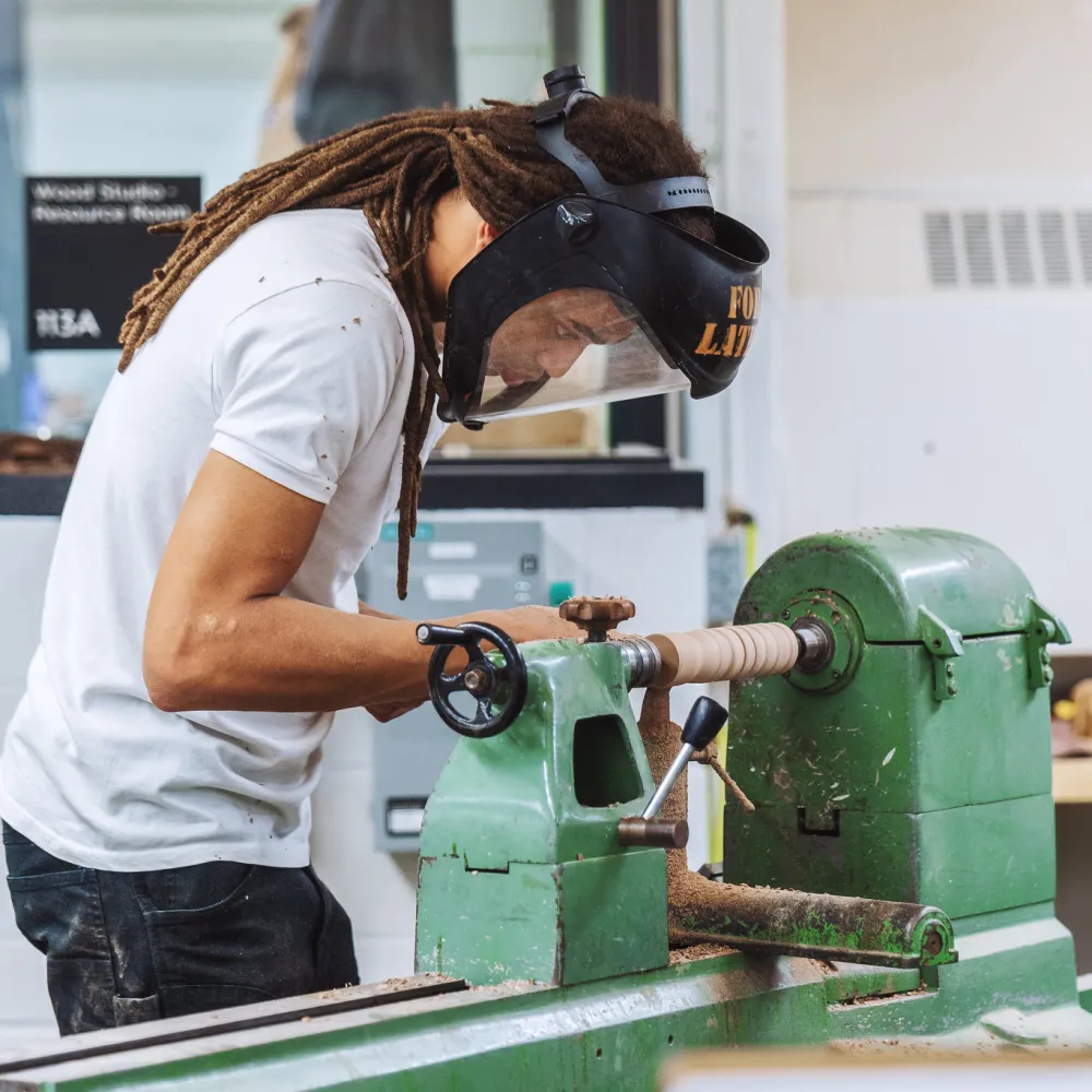 Student working at a lathe