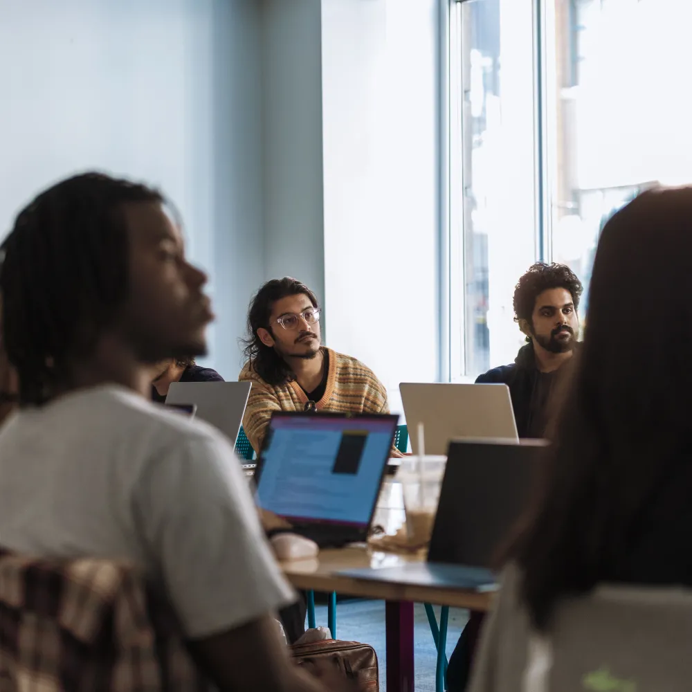 Students in a seminar room on laptops