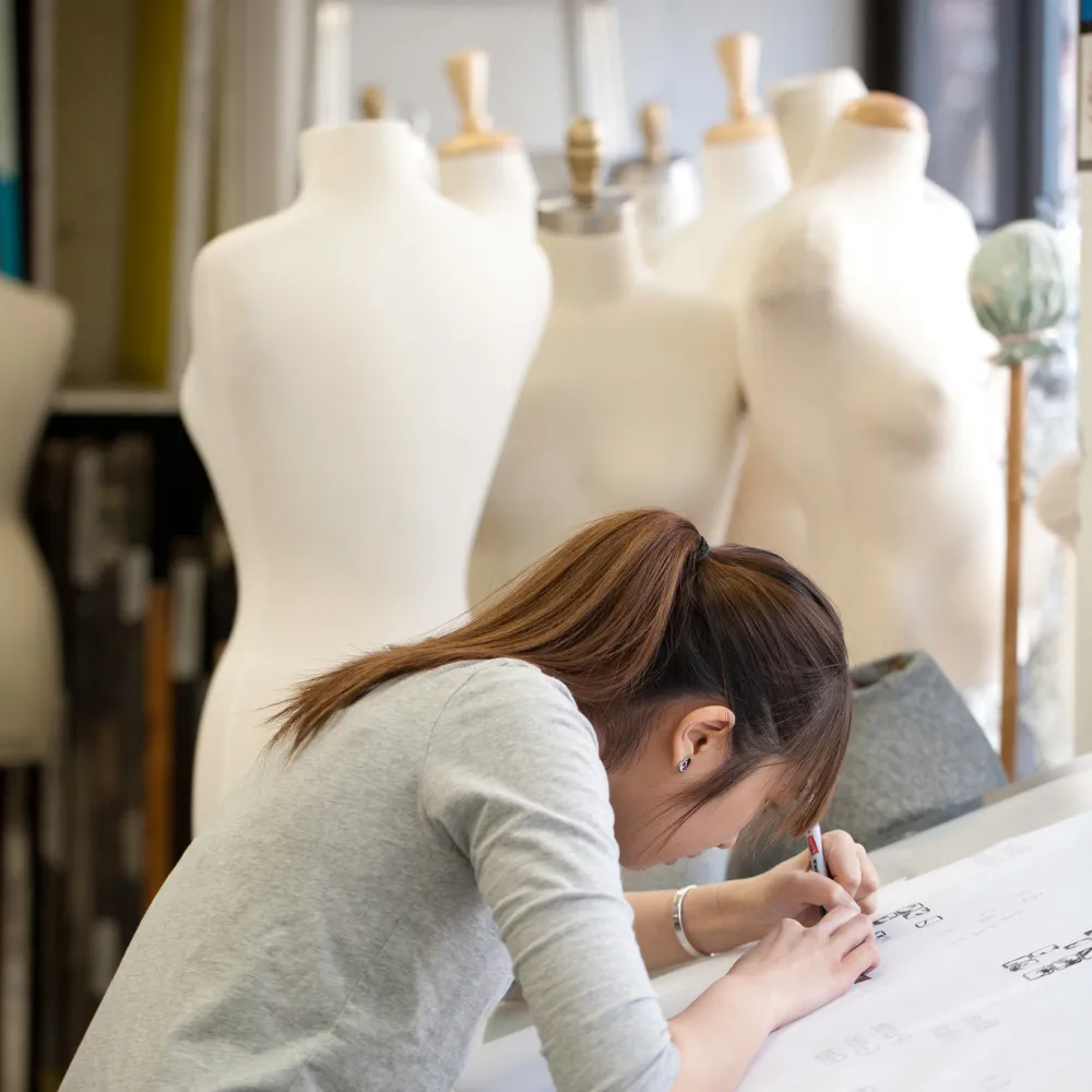 Student working on a drawing at a drafting table