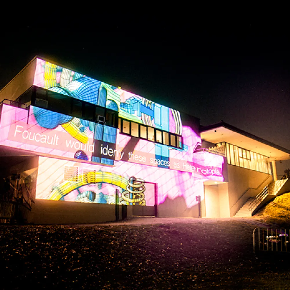 neon projections against the side of a building