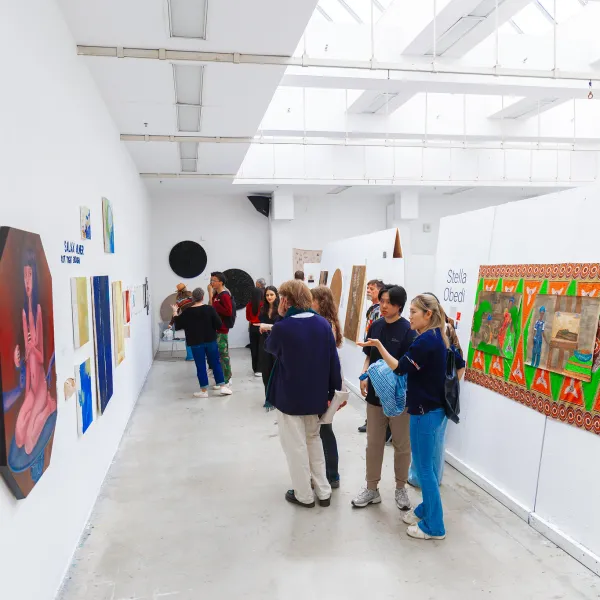 Group of people looking at art on gallery walls