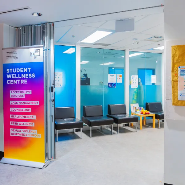 Waiting room with chairs and glass walls.