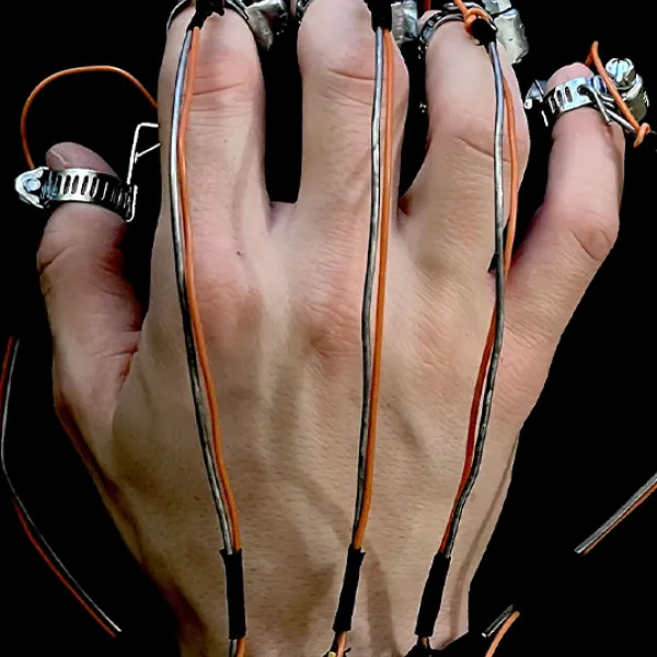 Photo of a hand wearing wires